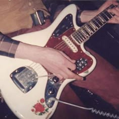 a person is playing an electric guitar