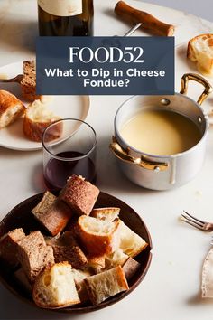 food sitting on top of a white table next to wine glasses and plates with bread