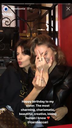 two women sitting next to each other in front of a red wall with the caption happy birthday to my sister