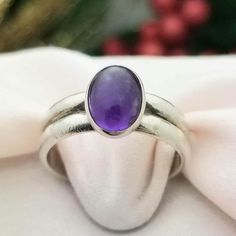 RETRO-STYLE Sterling Silver Oval Cabochon Amethyst Double Banded Ring- Beautifully Crafted.  Made in the 1980s.  Amethyst is the Birthstone for the Month of February. This Ring Would Make a Wonderful Birthday Gift! This Darling Ring is Petite is Size but Mighty in Color! Made from Solid and Stamped Sterling Silver, this Ring features an Oval Cut Cabochon Amethyst Gemstone that is a Rich, Deep Purple Color.  The Cabochon Amethyst measures 9mm in Length x 6mm Wide The Band measures 5mm in Width Si Luxury Amethyst Oval Cabochon Ring For Formal Occasions, Heirloom Cabochon Amethyst Ring For Anniversary, Vintage Amethyst Oval Cabochon Ring, Oval Cabochon Amethyst Heirloom Ring, Vintage Oval Amethyst Birthstone Ring, Heirloom Oval Cabochon Amethyst Ring, Classic Amethyst Cabochon Ring As Gift, Classic Amethyst Oval Cabochon Ring, Amethyst Oval Cabochon Ring For Anniversary