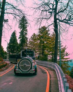 a truck driving down the road with trees in the background