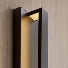 a wall light mounted on the side of a wooden wall