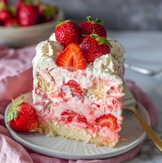 a slice of strawberry cake on a plate with strawberries