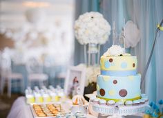 a table topped with a blue and yellow cake