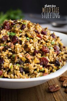 wild rice stuffing in a white bowl with pecans on the side