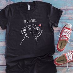 Let the world know that rescued pets are the BEST pets! Spread the compassion with this adorable t-shirt, featuring an actual rescue dog's portrait. Available exclusively from Original Sock Dogs. Question about size? Sizing chart is shown in last photo. ALL PROFITS go to Melissa's Menagerie's Second Chances (mscrescue.org This t-shirt is everything you've dreamed of and more. It feels soft and lightweight, with the right amount of stretch. It's comfortable and flattering for both men and women. Pitbull Drawing, Pitbull Shirts, Personalized Pet Gifts, Pitbull Puppy, Pitbull Mom, Pitbull Lover, Second Chances, Dog Mom Gifts, Plush Dog