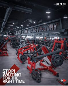 a gym with rows of red and black equipment in the middle of it, on top of a gray floor that says stop waiting for the right time