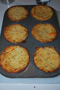 several baked food items in a pan on a stove top, ready to be cooked