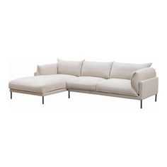 a white sectional couch sitting on top of a wooden floor next to a white wall