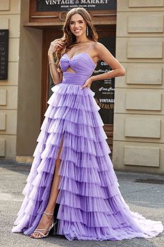 a woman in a purple dress posing for the camera