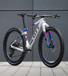 a white and blue bike parked in front of a building