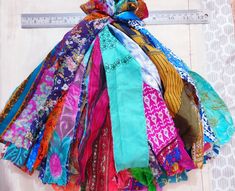 a multicolored scarf is hanging on a ruler