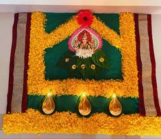 a decorated wall with flowers and candles on it