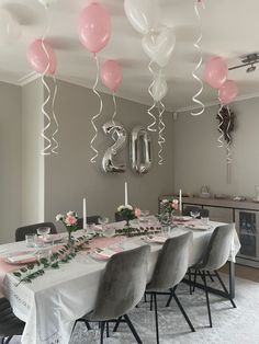 a dining room table with balloons and flowers on the table in front of it is decorated for a 30th birthday party