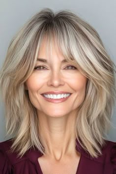 Save this pin for the best shag hairstyles for women over 50. This shoulder-length shag gives the hair a stylish lift with layers that create subtle volume. The layers also bring out a stunning textured effect. Over 50 Hairstyles For Women Long, Med Shag Hairstyles, Angle Bob, Shoulder Length Hair With Bangs, Ash Blond, Shaggy Bob Hairstyles, Medium Shag, Modern Shag Haircut