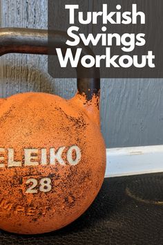 an orange kettle with the words turkish swings workout 28 written on it in white lettering