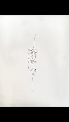 a black and white drawing of a flower on a sheet of paper with the word love written in cursive writing