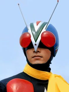 a man wearing a helmet with red, white and blue balls on it's head