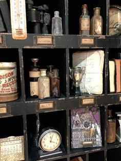 an old book shelf filled with lots of books and knick - knacks