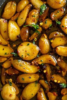 cooked potatoes with herbs and seasoning in a pan