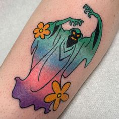 a colorful tattoo on the arm of a person with a flower in her hair and an image of a ghost