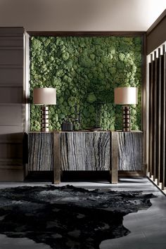 a living room with two lamps and a wall covered in moss plants on the walls