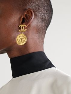 Each piece of vintage Chanel jewelry comes with a story of its own, told through the unique marks and gentle wear. Sourced by Susan Caplan, these gold-plated earrings have interlocking 'CC' emblems as posts and dainty charms engraved with the same iconic motif. The hammered finish catches the light beautifully.   This Chanel item has been authenticated by Susan Caplan. Susan Caplan is not affiliated or endorsed by Chanel Vintage Chanel Earrings, Vintage Chanel Jewelry, Winter Wishlist, Flat Dress Shoes, Chanel Earrings, Branding Inspo, Chanel Jewelry, Chanel Vintage, Earrings In Gold