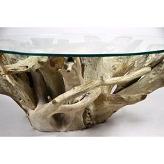 a table made out of driftwood with glass top