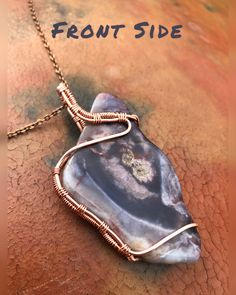 a wire wrapped pendant is shown with the words front side on it and an image of a