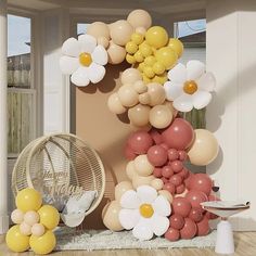 a room with balloons and flowers on the wall