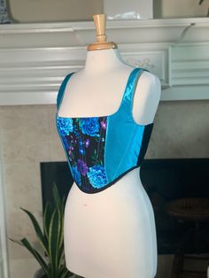 Over-bust corset with flexible boning and black lacing in back.  Indigo black floral cotton flanked by light blue silk and velvet sides. Sizing is pretty flexible because of lace-up closure. Message me if you have questions! Mannequin's measurements - Waist: 27" Bust: 37" Generally here are the sizes (US sizing): Small: 4-8 (as seen in photos) Medium: 8-12 Large: 12-16 XL: 16-20 Please send me your bust and waist measurements when ordering so I can make sure it will fit perfectly! Blue Fitted Corset With Corset Back, Fitted Blue Corset With Corset Back, Blue Sleeveless Fitted Bodice Corset, Sleeveless Blue Corset With Fitted Bodice, Fitted Sleeveless Blue Corset, Blue Underbust Corset With Fitted Bodice, Fitted Blue Spring Corset, Blue Fitted Corset For Spring, Fitted Blue Corset For Spring