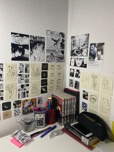 a white desk topped with lots of books and pictures