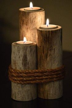 three wooden candles with rope wrapped around them