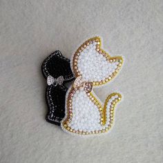 two black, white and gold sequins with bows on top of each other