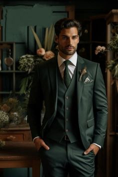 a man wearing a suit and tie standing in front of a wooden shelf filled with flowers