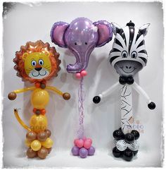 three balloons in the shape of animals and zebras