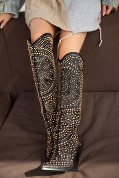 This baby sells out every time we have her in stock. She is a glam cowboy boot featuring a studded faux leather upper, pointed toe, below the knee length, a rounded Western-inspired shaft silhouette, chunky block heel, and slip-on fit. Style these stunning statement shoes with your favorite outfit for your next music festival! 4” heel height 17” shaft height Glam Cowboy, Black Cowgirl Outfit, Womens Boots Winter, Western Glam Outfit, Tall Western Boots, Tall Western Boot, Black Western Boots, Denim Party, Western Glam