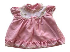 This is a beautiful vintage Pink baby dress with flower detail for 9 Mo. very delicate feeling dress! Two button closure on the back. This dress would be perfect for Easter, Church, or a picnic in the park. Anytime you want to show off your beautiful baby would be a time to wear this wonderful item. *email me if you need measurements very slight and light marking on the back top right arm area. sooo unnoticeable. price reflects this. Sweet Lace Trim Dress For Garden Party, Sweet Dress With Lace Trim For Garden Party, Cute Vintage Dress With Lace Trim For Summer, Cute Summer Vintage Dress With Lace Trim, Cute Vintage Summer Dress With Lace Trim, Cute Vintage Dress With Lace Trim For Spring, Cute Daywear Dresses With Peter Pan Collar, Cute Ruffled Vintage Dress For Garden Party, Cute Vintage Ruffle Dress For Garden Party