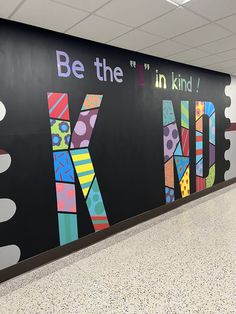 a wall that has some kind of art on it in the middle of an airport