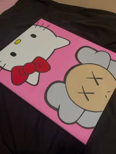 a hello kitty painting on a black sheet