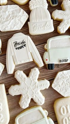 decorated cookies are arranged on a wooden table