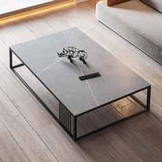 a coffee table with an animal figurine on it in the middle of a living room