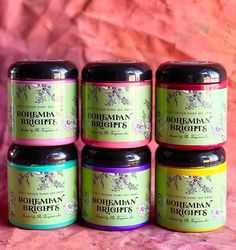 six jars of bohemian brights on a pink background