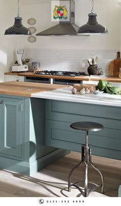 a kitchen with blue cabinets and an island