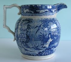 a large blue and white vase sitting on top of a table