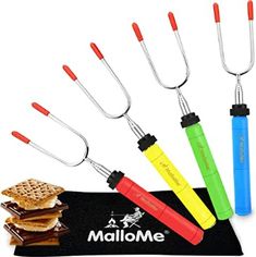 the multi - colored utensils are next to some waffles and crackers