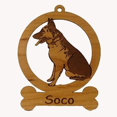 a wooden ornament with a german shepherd dog on it's side and a bone in the middle