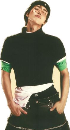 a man with his hands on his hips wearing a black shirt and green trims