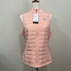 Everyday Warmth While Carrying A Sleek Style. The Nike Therma-Fit Technology Was Designed To Keep You Warm On Those Chilly Runs In The Off-Season. This Pink Vest Delivers A Clean Fit, And The Lightweight Design Helps Keep You Warm In Cool Autumn Or Winter Temperatures. The Secure Pockets Double As Storage For Headphones Or Hand Warmers. We Also Love This Vest Because You Can Layer Up Over Your Favorite Top And Hit The Road. Style: Dd6035-800 Spring Sports Fitted Outerwear, Nike Puffer Jacket, Nike Vest, Black Sportswear, Cool Autumn, Loose Vest, Nike Sportswear Women, Grey Quarter Zip, Lightweight Vest