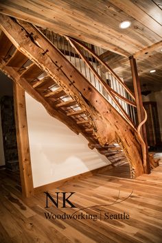 a wooden stair case in an unfinished room